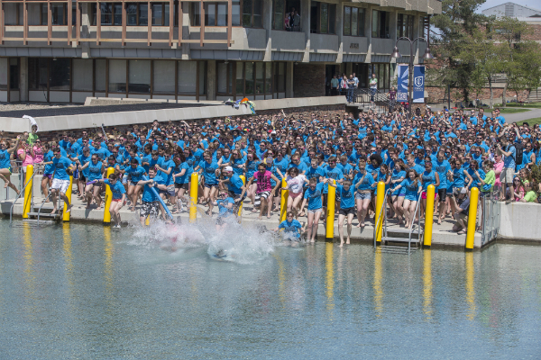 Students jumping into the Dillingham fountains